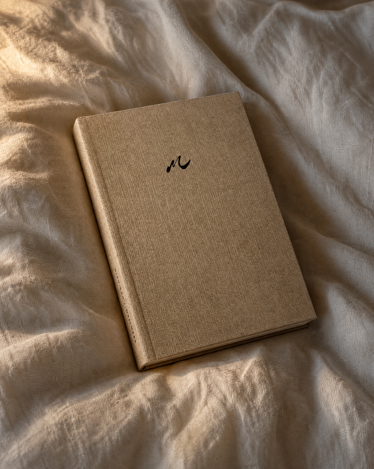 The Mindfulness Journal open on a bed, showing a guided morning and evening page